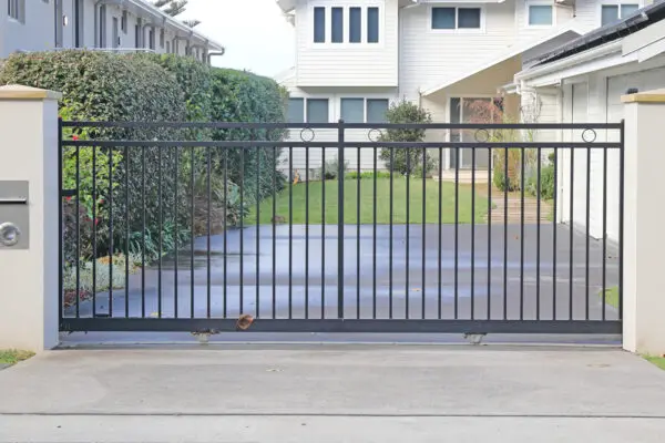 Automatic slide open front gate with vertical metal bars
